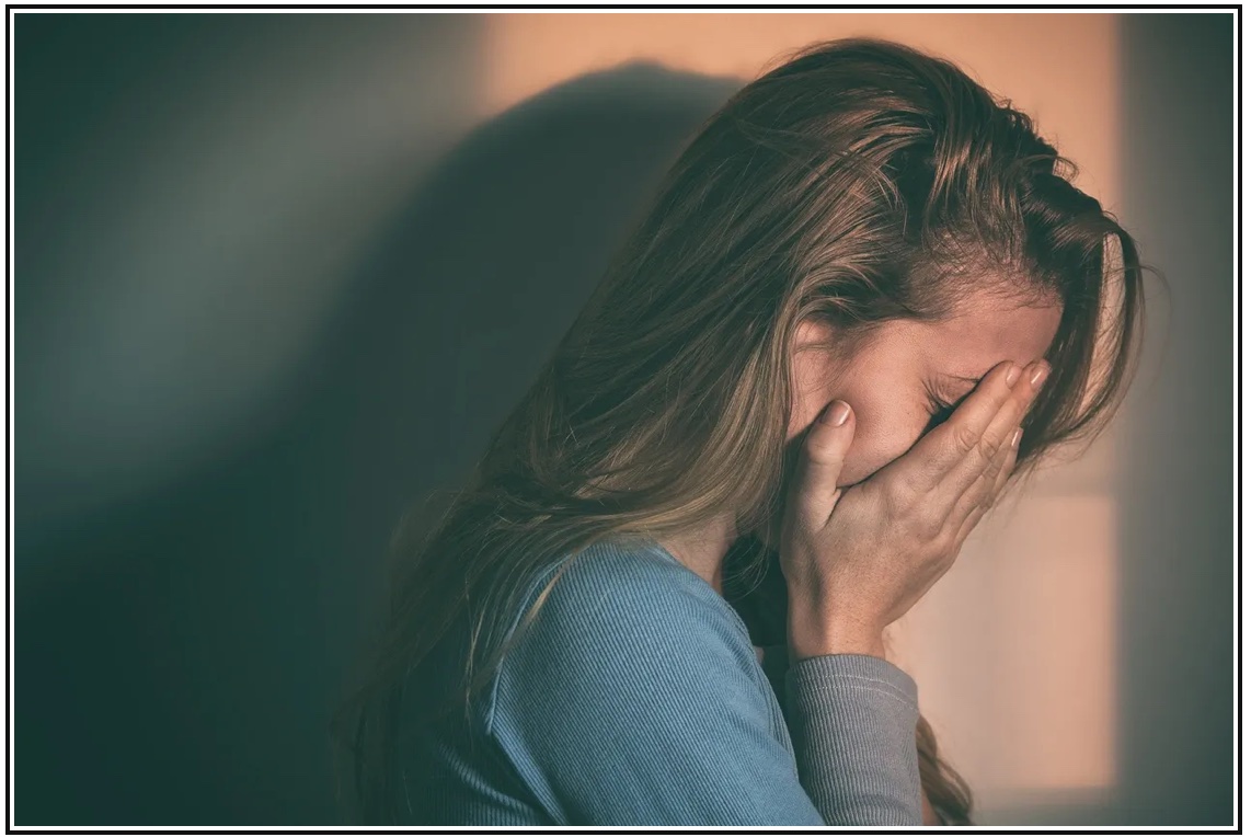 Woman experiencing unexplained illness — a common presentation in mould-affected homes